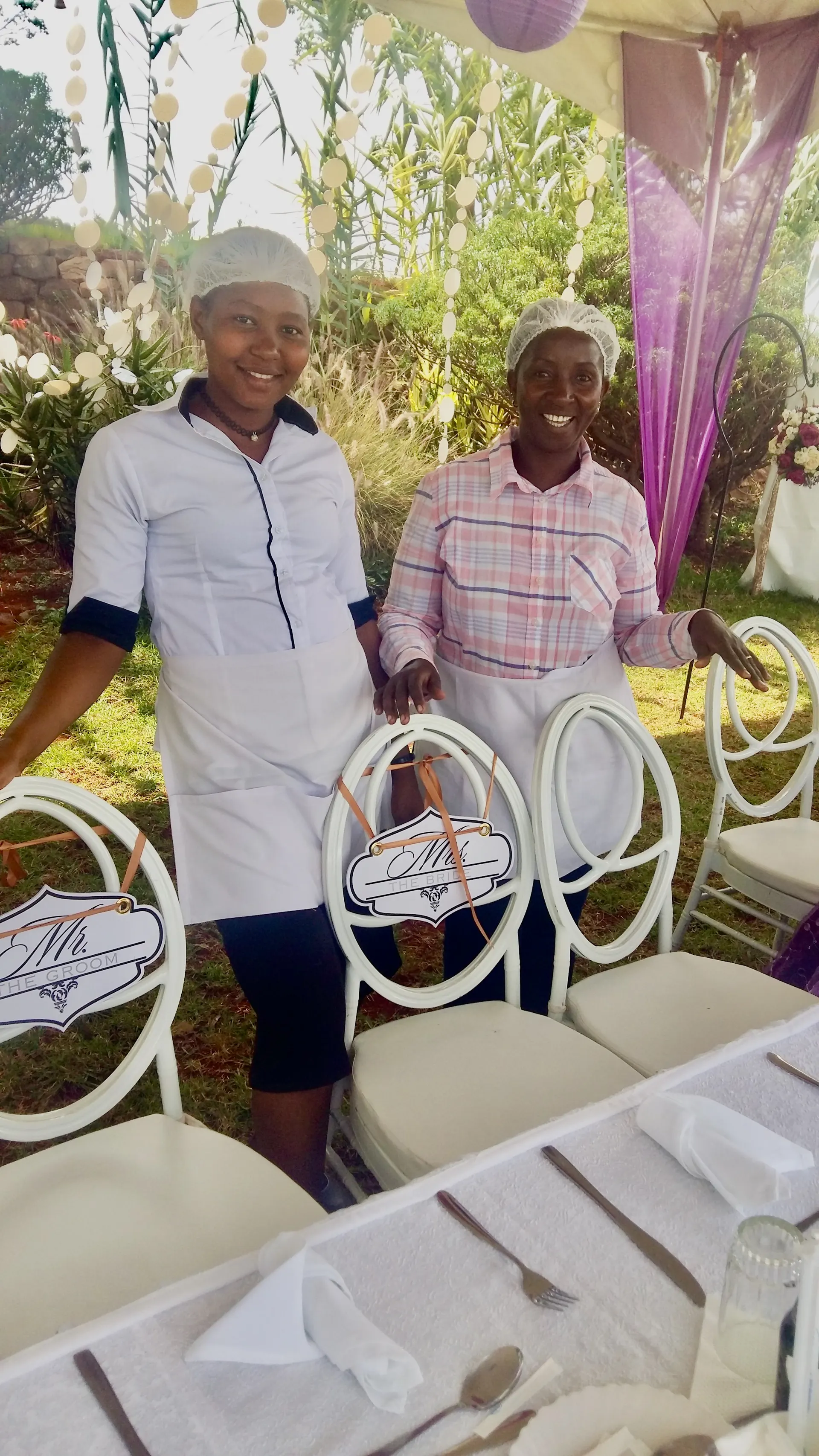 Nagira Catering team smiling on-site, standing by the wedding table setup